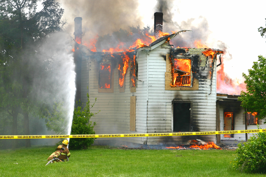 Two Firemen Trying to Put out a House Fire